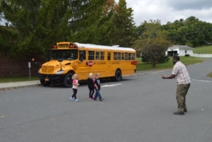 Students practice crossing in front of stopped school bus