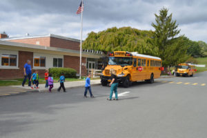 Students walk across school parking lot