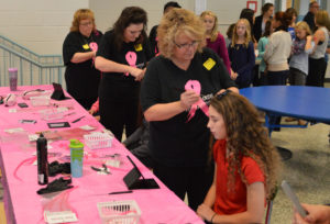 Students getting pink hair extensions