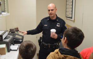 Officer Eckel gives tour of police station to students