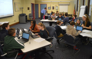 Student advisory council works on chromebooks in conference room