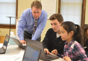 Superintendent Simons works with students