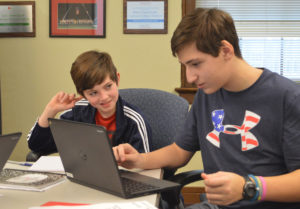 Two students work together on a chromebook