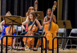 Students play instruments on stage
