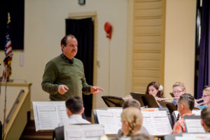 Mr. Halak conducts band on stage