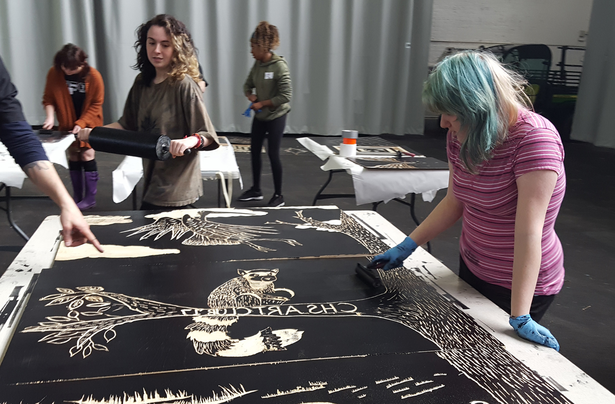 Columbia students roll ink onto their design