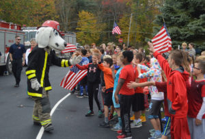 Sparky gives high fives to students at Bell Top