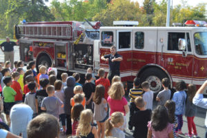 Firefighter talks to students at Genet Elementary School