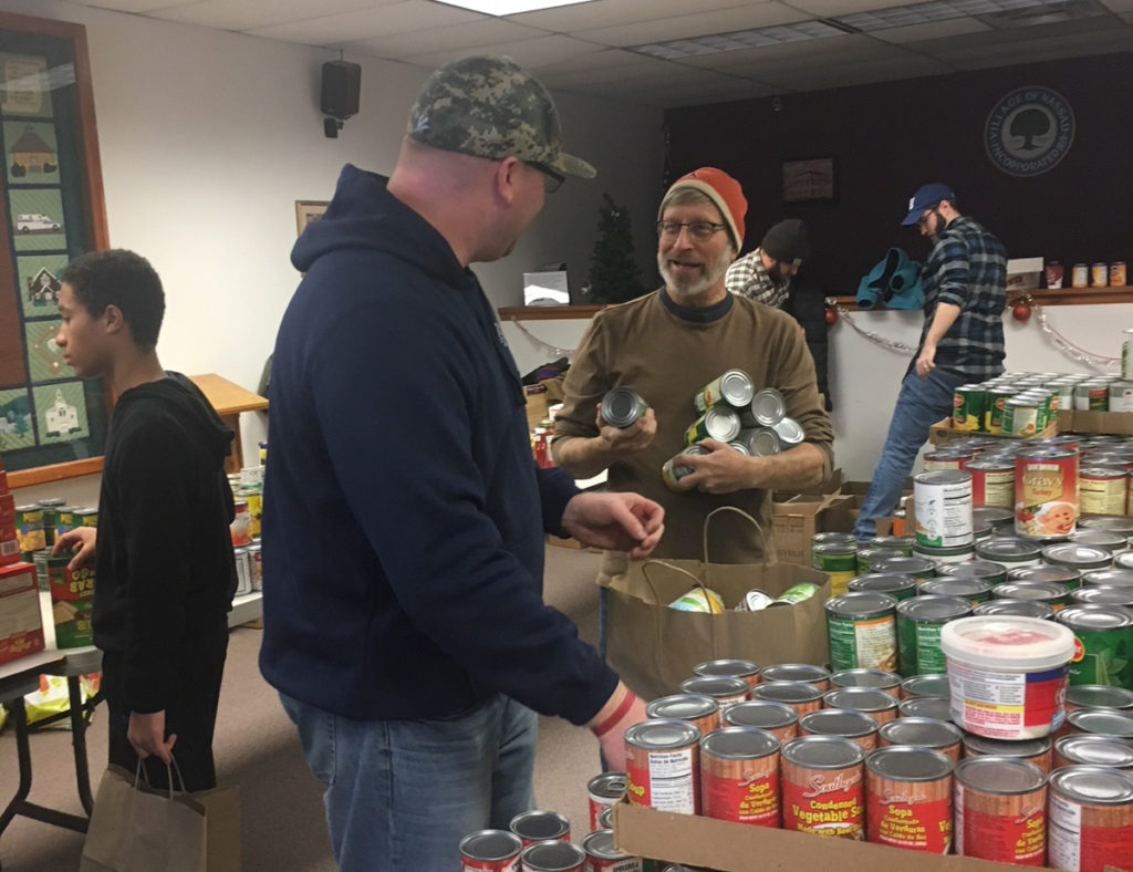 East Greenbush teachers package holiday dinner baskets at the Nassau Resource Center Food Pantry