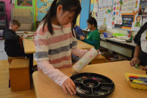 A student decorates her kaleidoscope