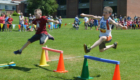 Students jumping over hurdles