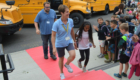 Bus drivers walk on a red carpet into Bell Top
