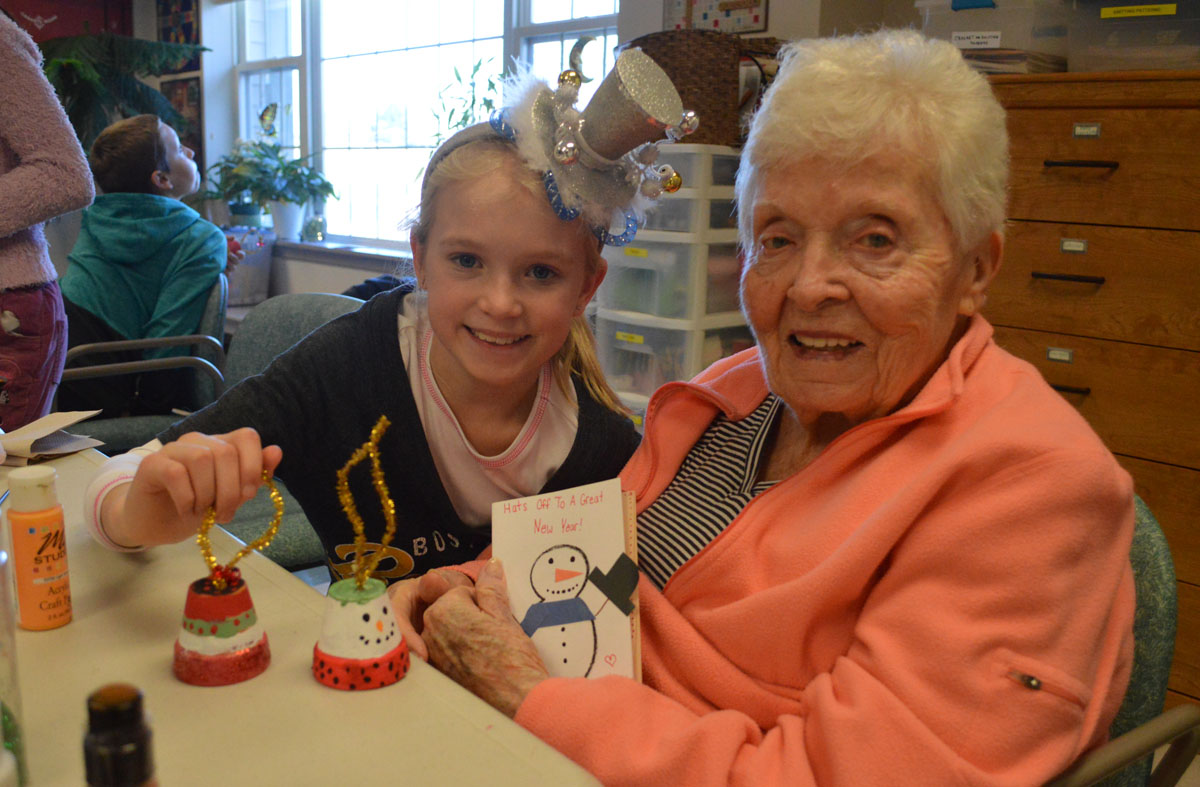 Kaelynn Stringer, a 6th grader from Howard L. Goff Middle School, helps Patricia Finnerty make a Christmas ornament on Tuesday morning at Beverwyck in Slingerlands.