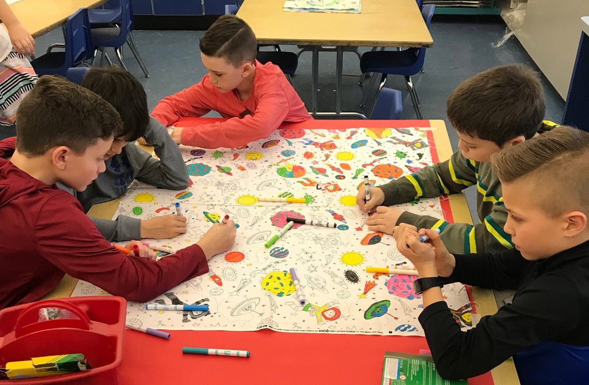 Students color pillowcases 