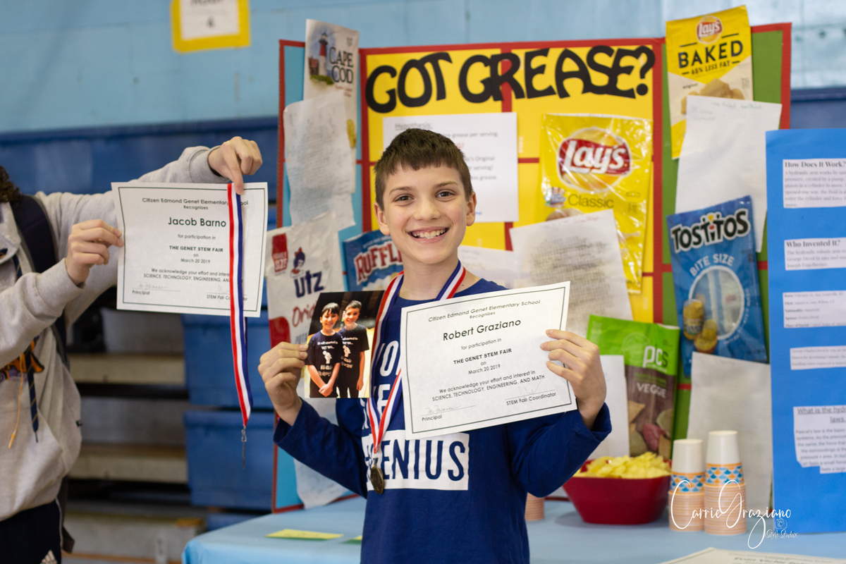 Student holds up certificate