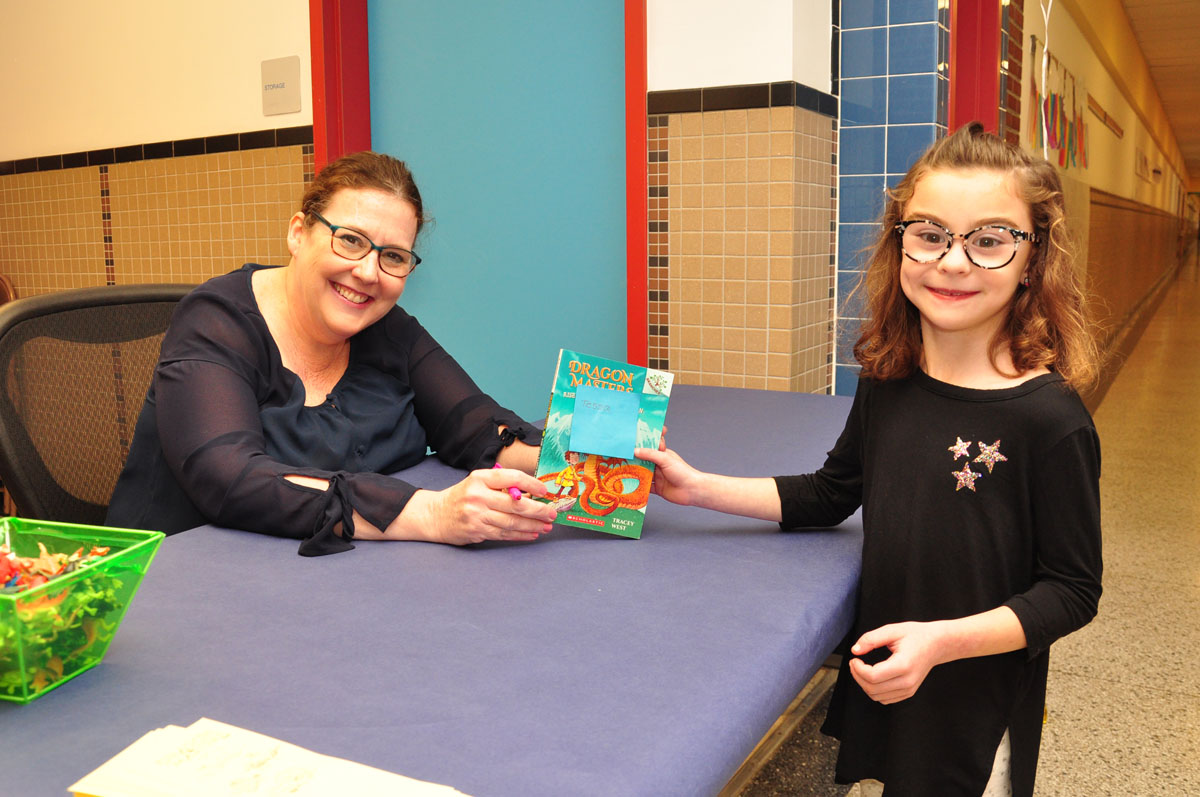 Tracey West signs book for student