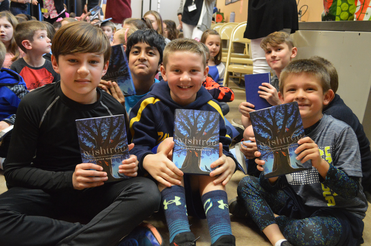 Students holding their new books