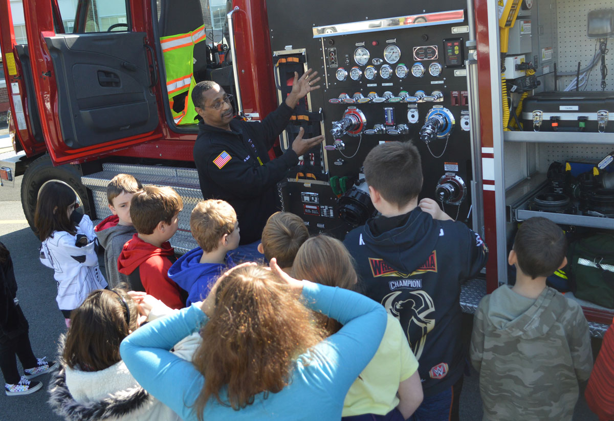 Firefighter talks with students