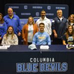 Columbia student athletes with their parents at signing ceremony