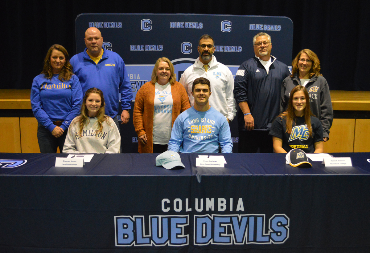 Columbia student athletes with their parents at signing ceremony
