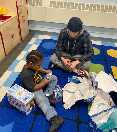 Columbia student visiting with a St. Anne's Institute preschool student