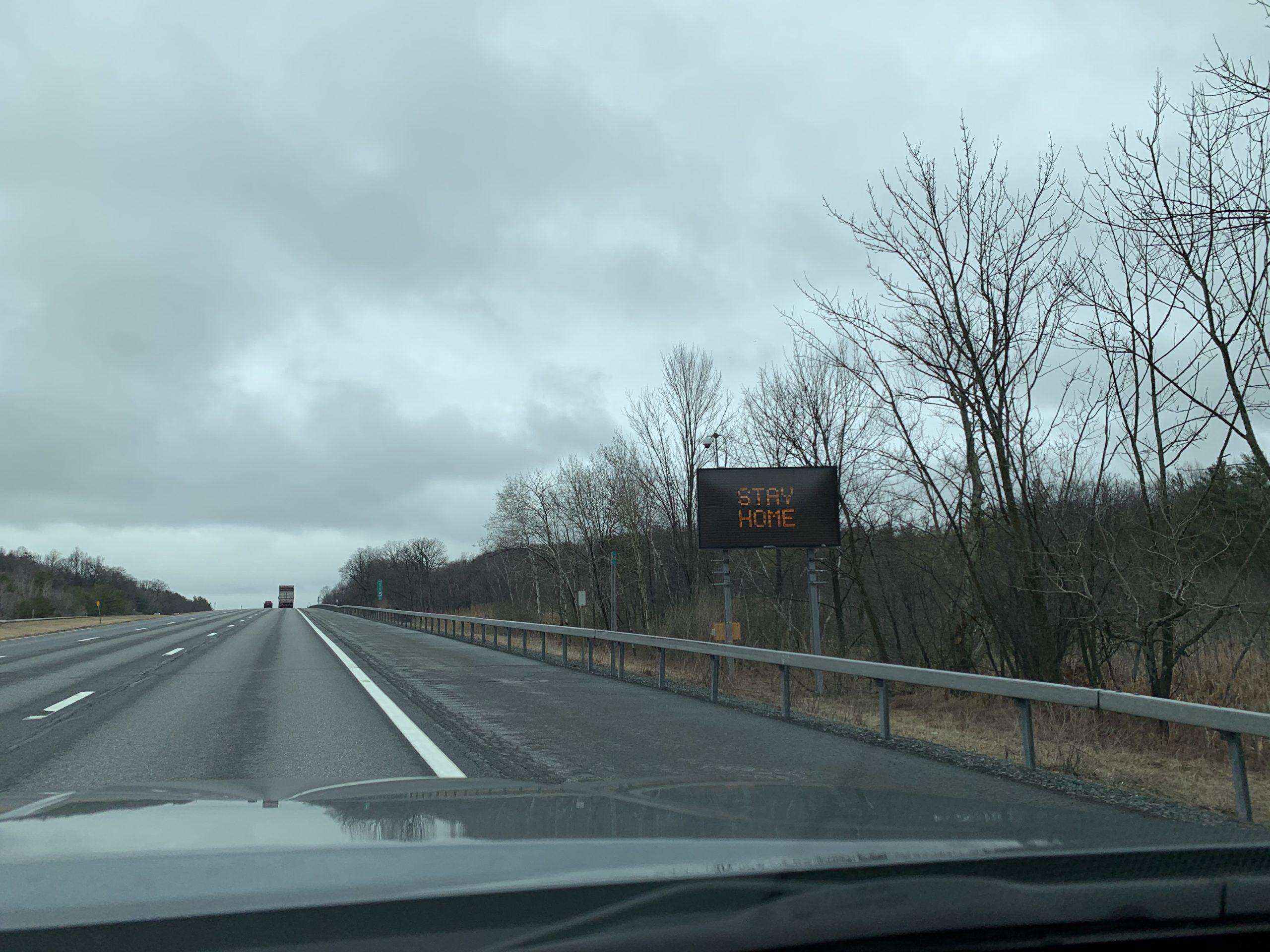"Stay Home" sign displayed on the roadside
