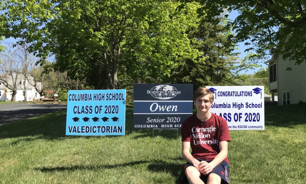 Owen Ball with valedictorian sign