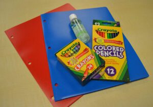 Pocket folders, colored pencils, crayons and hand sanitizer