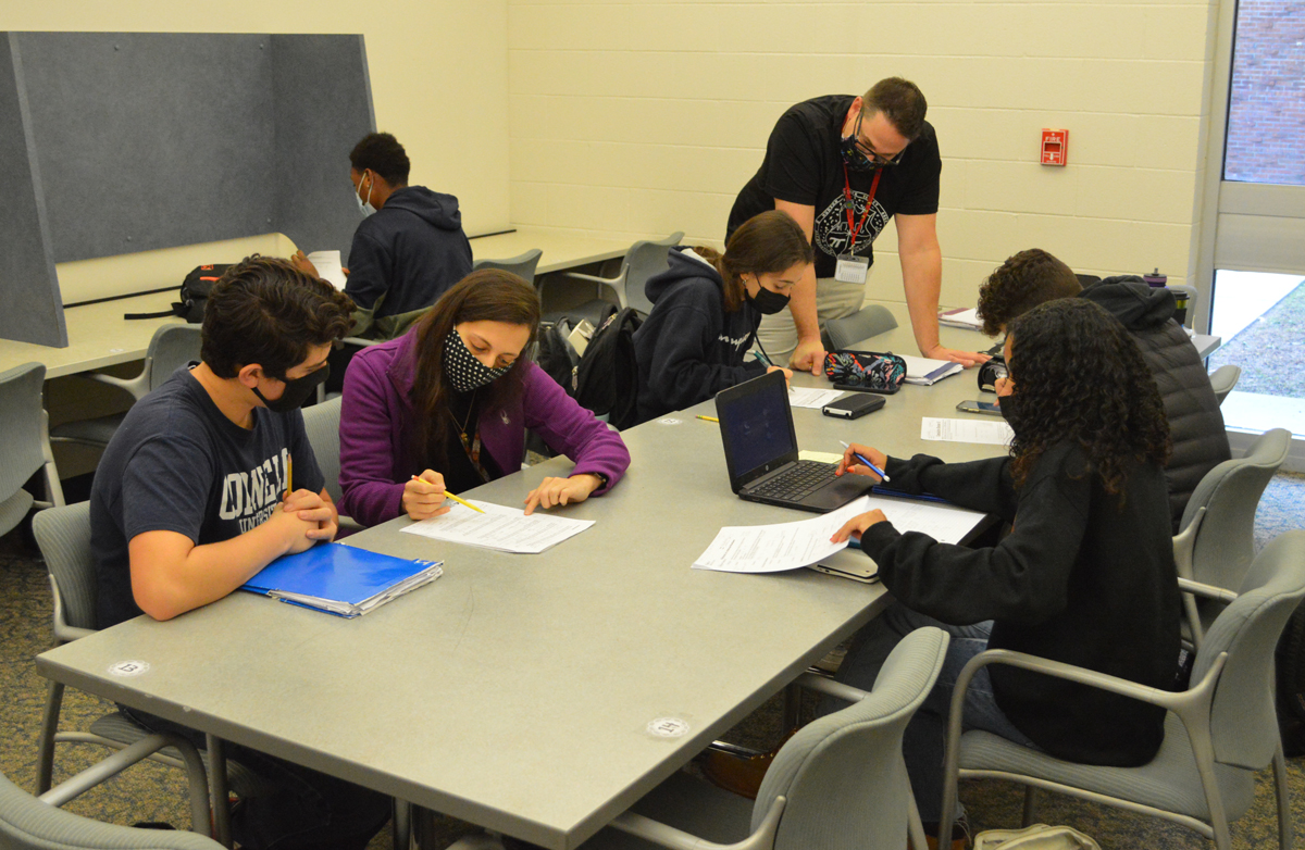 Teaching Assistant Cherylyn Grisafe and Math Teacher Dan Batcher work with students in the Math Learning Resource Center at Columbia High School.
