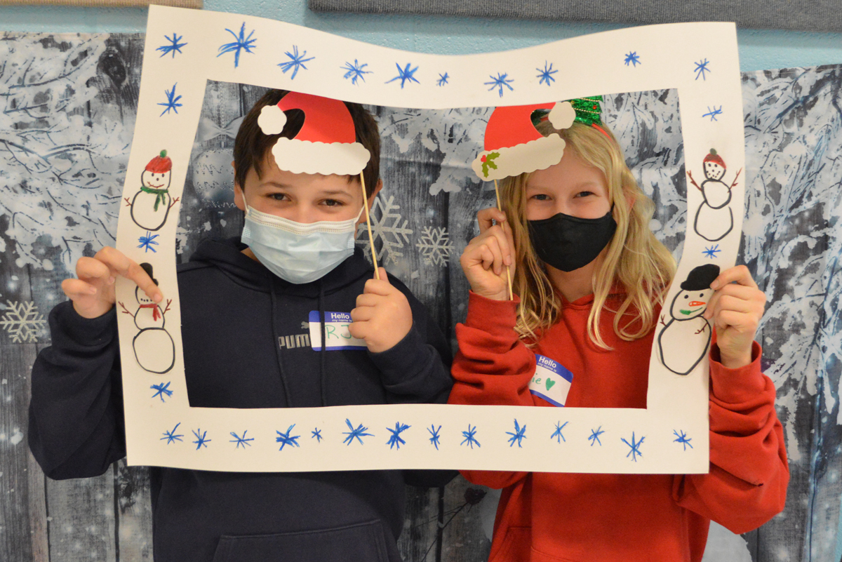 Students in a holiday-themed photo booth