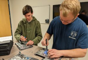 Students repair chromebooks at the Columbia Student Help Desk