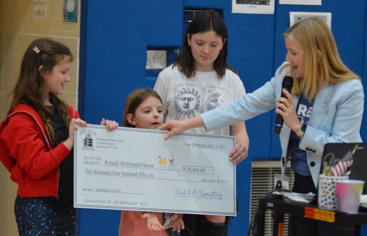 Principal Squillace and Red Mill students present a check for the Ronald McDonald House