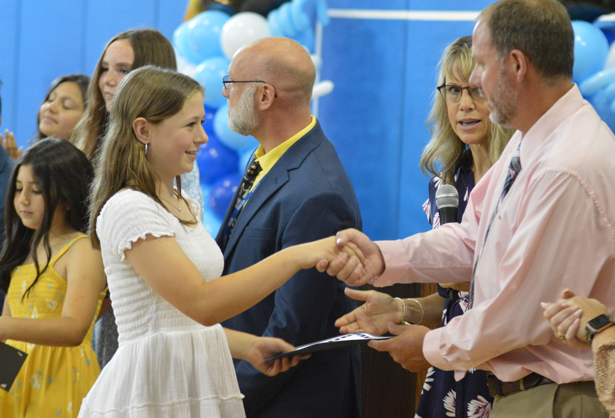 Bell Top student receives certificate at Moving Up Ceremony