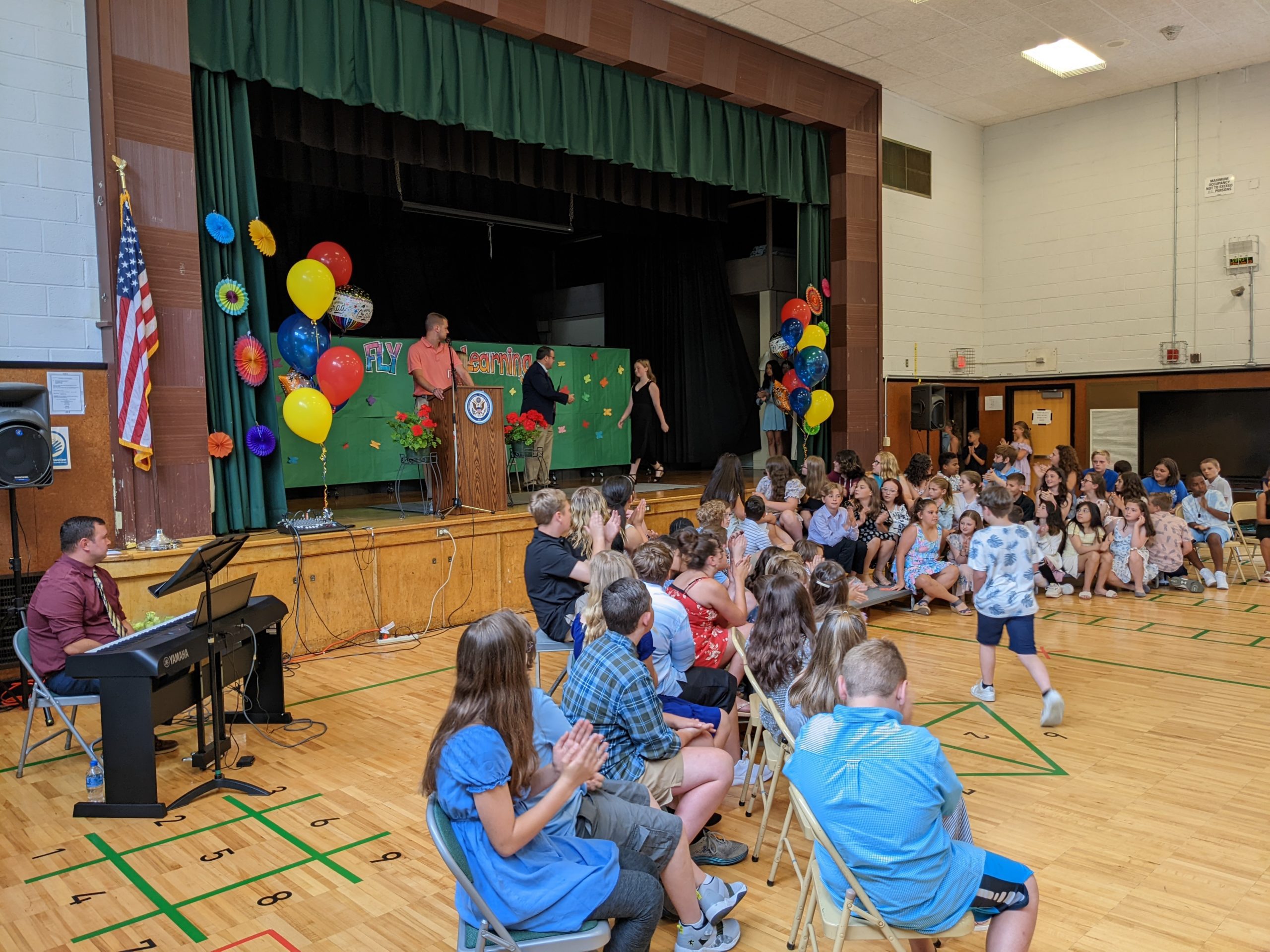 Green Meadow students receive certificates.