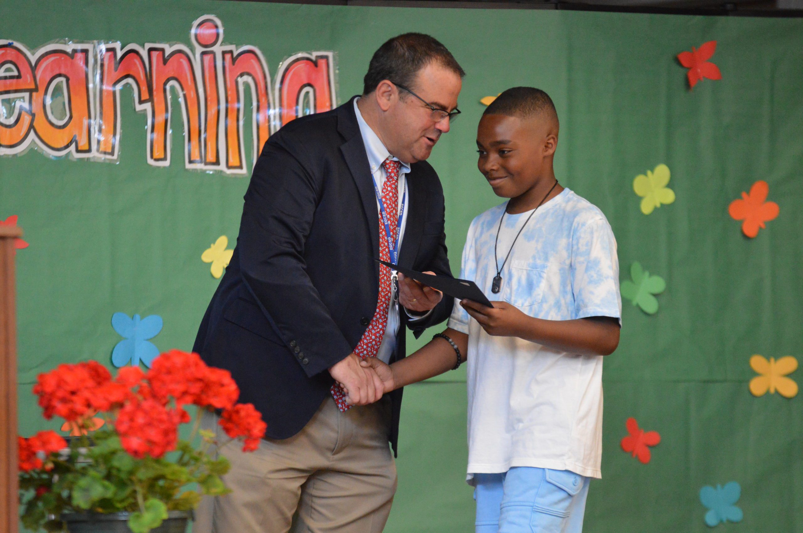 A Green Meadow student receives their certificate.