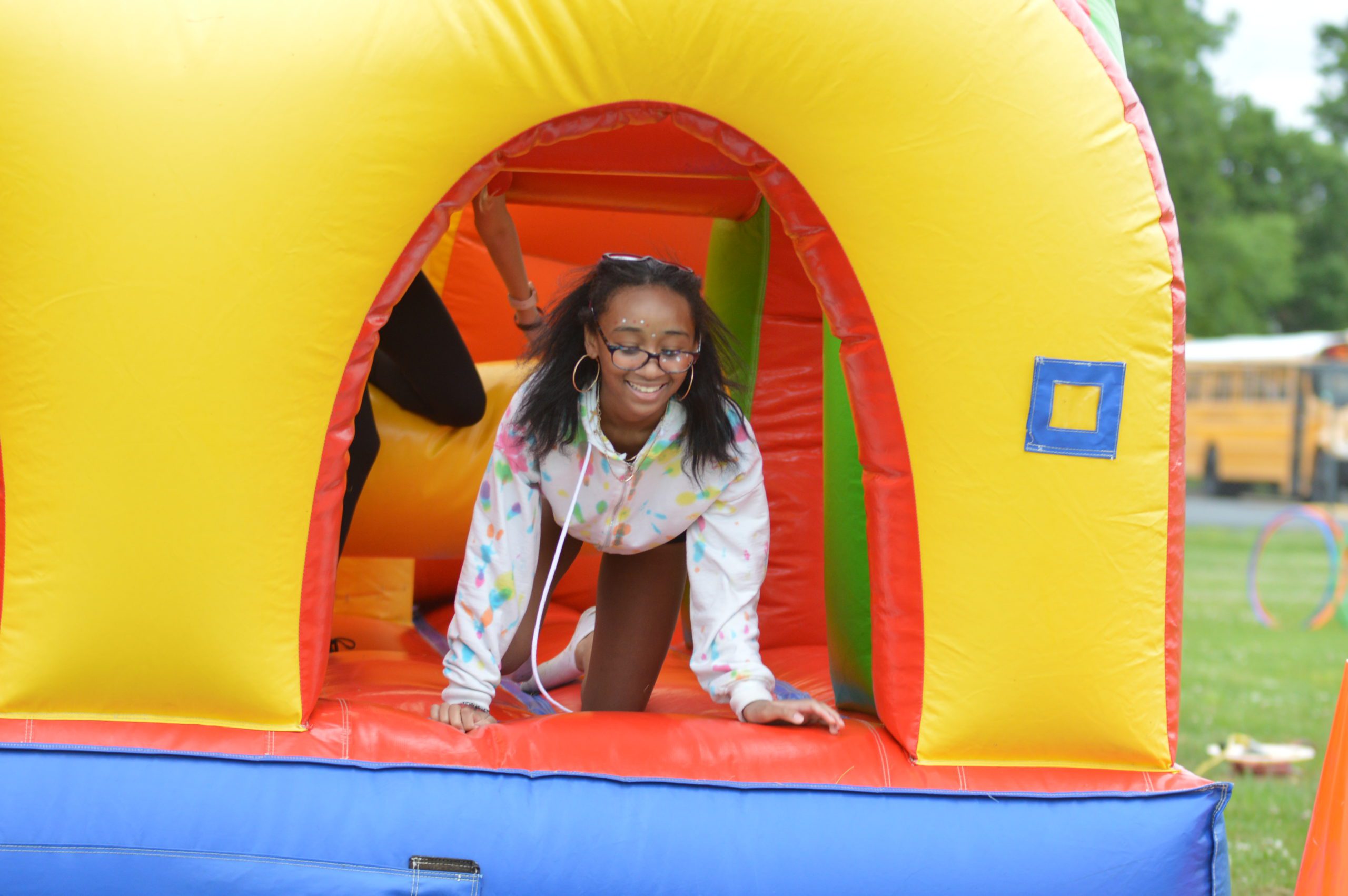 Student climbs through a bounce house at Goff Field Day