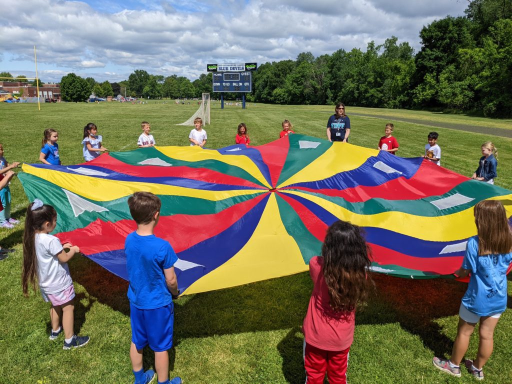 Students play parachute games at Genet Field Day