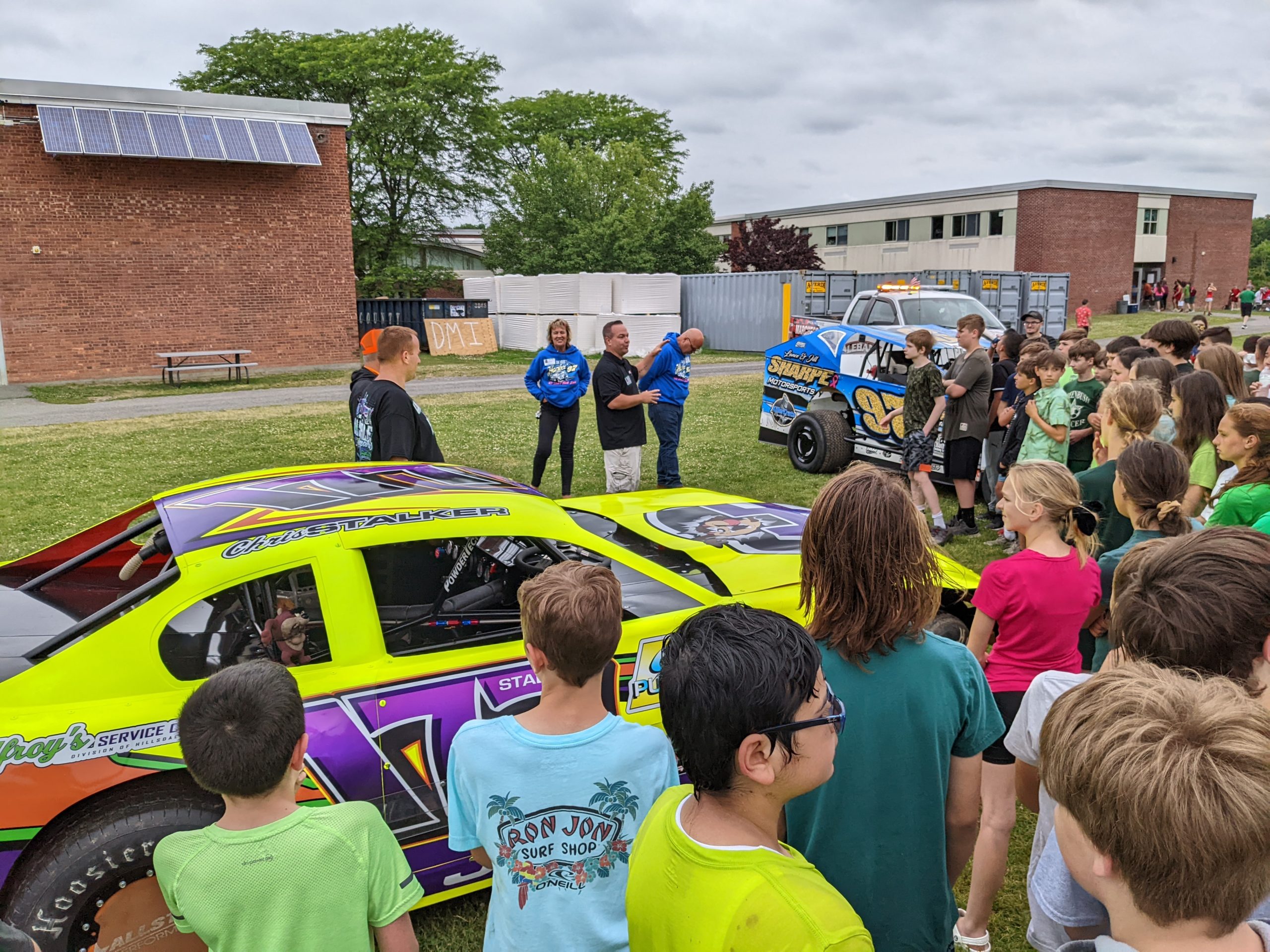 Students looking at racecars at Goff Field Day