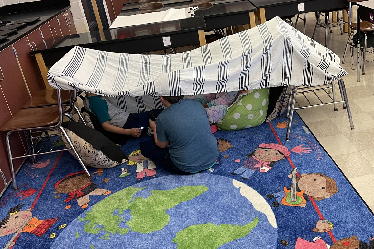Summer School students make a tent during Camping Week