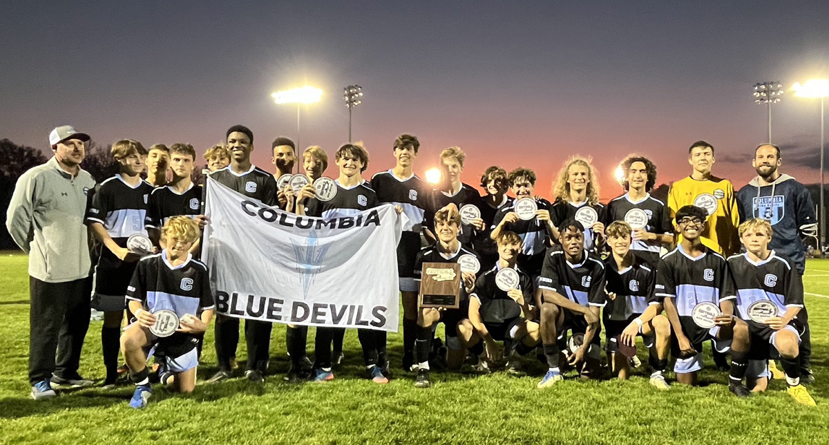 Columbia boys' soccer team holding sectional championship patches