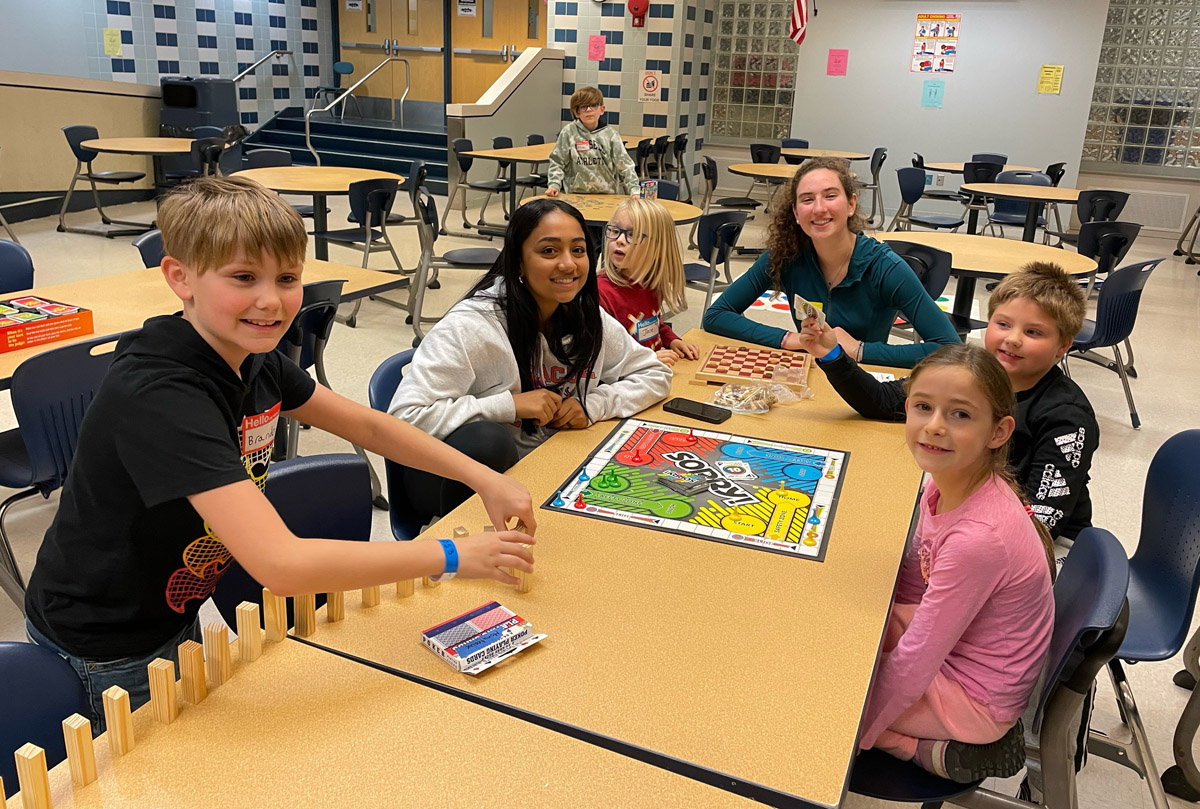 Students playing a board game at Parents Night Out