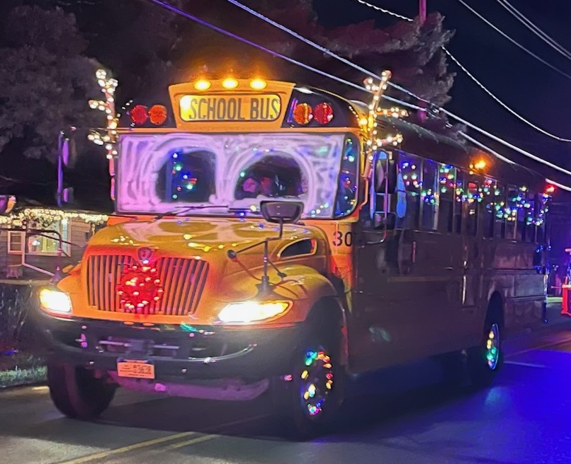 Students and Staff Ride Rudolph-Themed School Bus at Holiday Parade