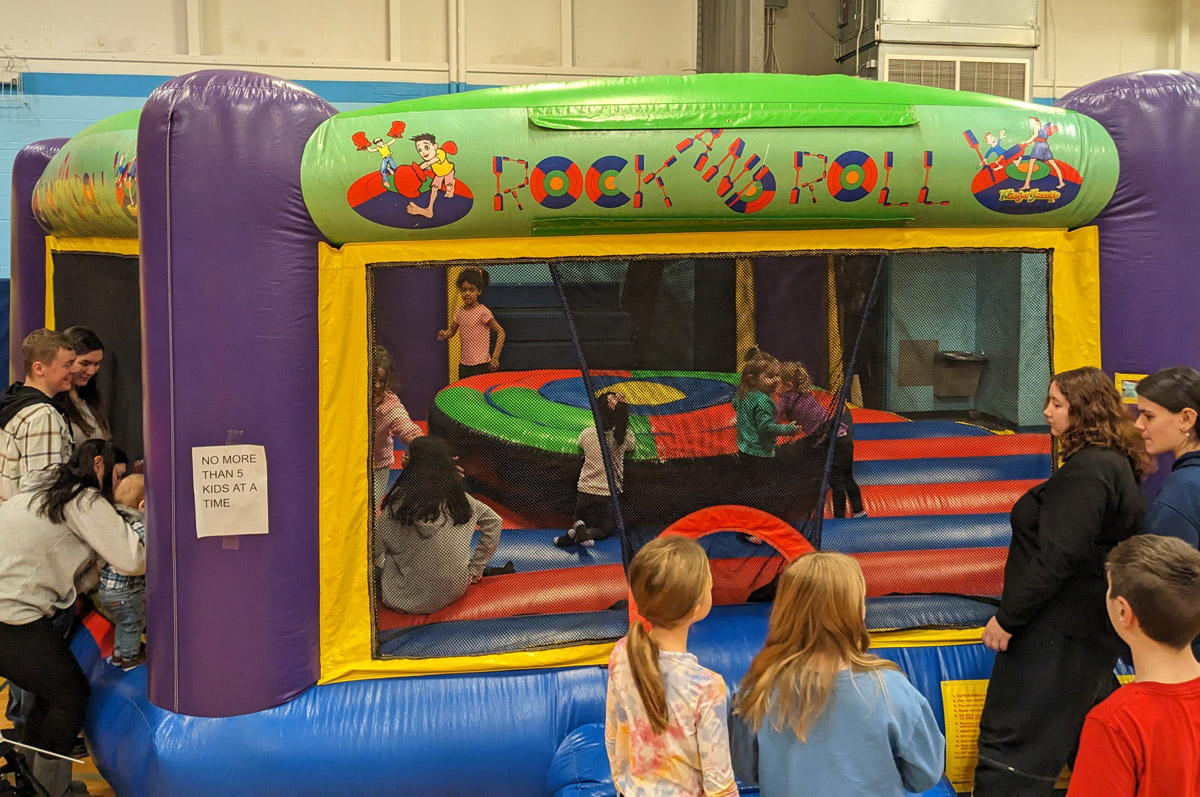 Kids jumping in a bounce house at Winterfest