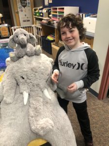 A student with Veda the stuffed elephant at the East Greenbush Library