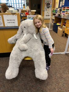 A student with Veda the stuffed elephant at the East Greenbush Community Library