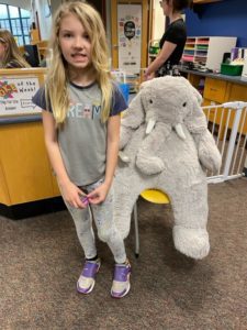 A student with Veda the stuffed elephant at the East Greenbush Community Library