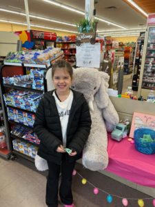 A student with Veda the stuffed elephant at Family Dollar in Nassau
