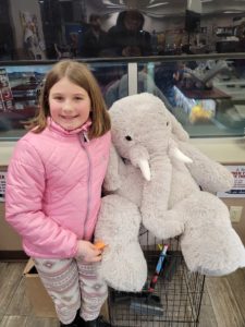 A student with Veda the stuffed elephant at Stewart's in Nassau