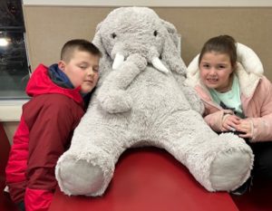 Students with Veda the stuffed elephant at Stewart's in Nassau