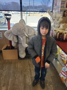 A student with Veda the stuffed elephant at Stewart's in Nassau
